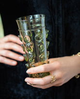 Styled image featuring the Bollenglass Design Green Dot Water Glass.