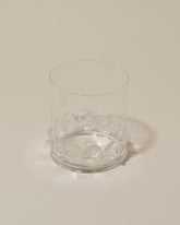 Closeup details of the Bollenglass Design Clear Dot Whiskey Glass on light color background.