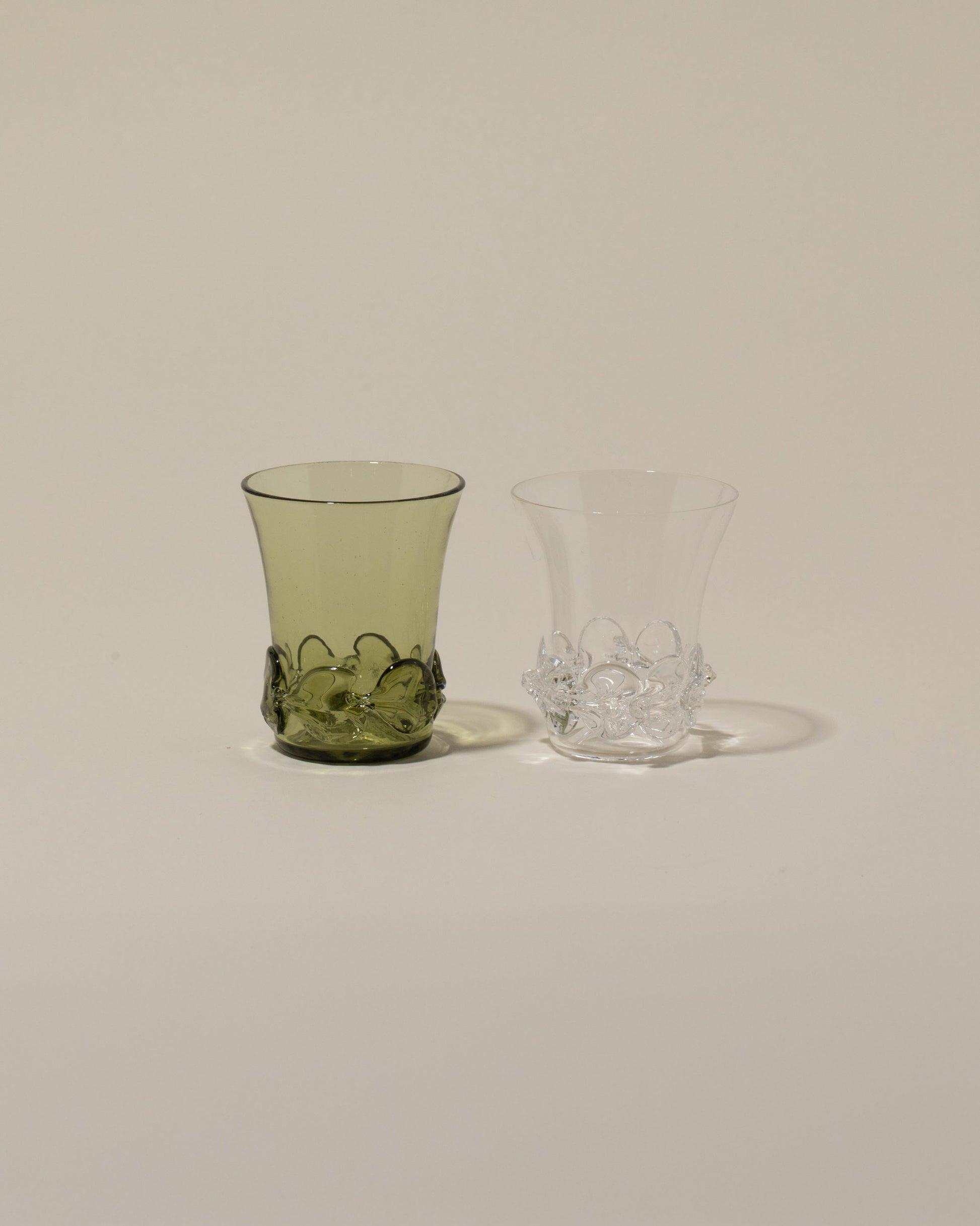 Bollenglass Design Clear Liquor Glass and Green Liquor Glass on light color background.
