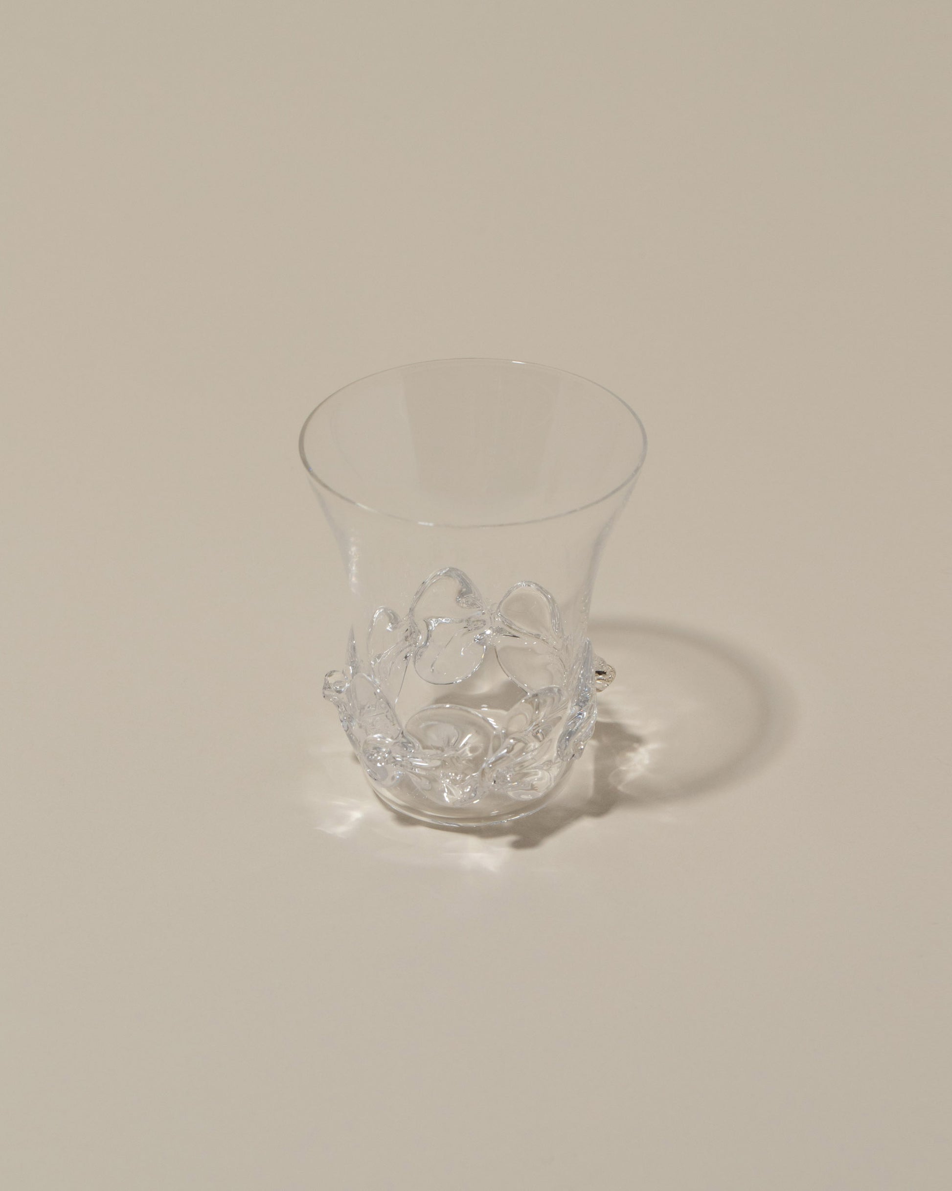 Closeup details of the Bollenglass Design Clear Liquor Glass on light color background.