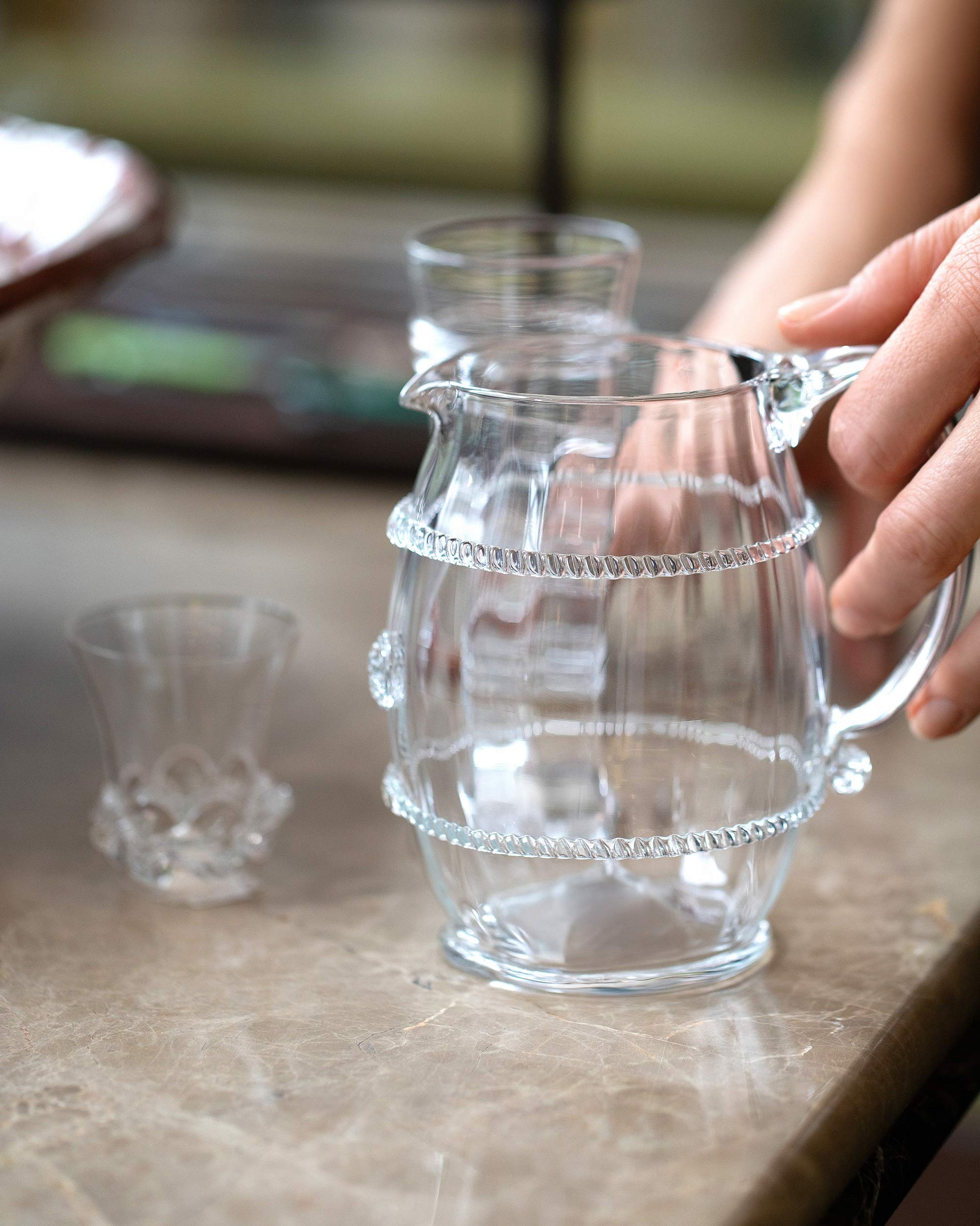 Styled image featuring the Bollenglass Design Clear Petite Pitcher.