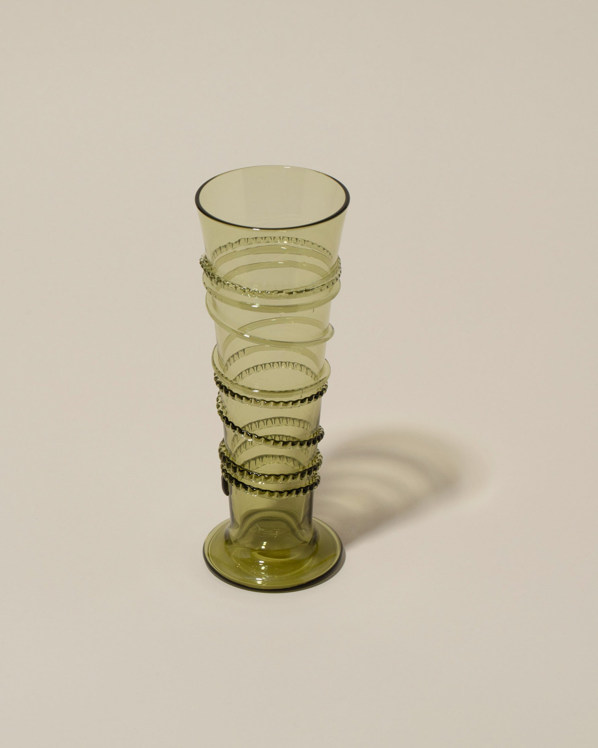 Closeup details of the Bollenglass Design Green Petite Spiral Tumbler on light color background.