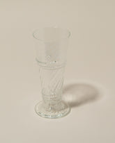 Closeup details of the Bollenglass Design Clear Small Spiral Tumbler on light color background.