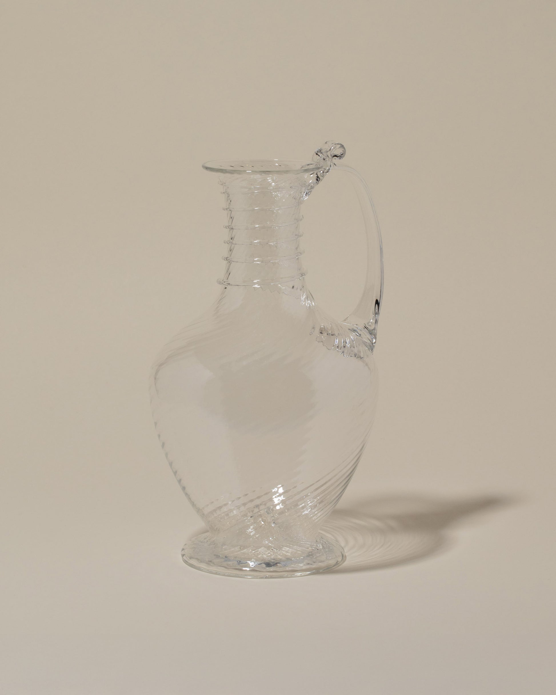Bollenglass Design Clear Spiral Jug on light color background.