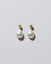 Grebe Pearl Earrings on light color background.