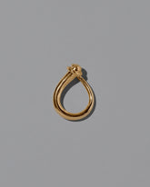View from the side of the CRZM 22k Gold Boulder Ring on light color background.