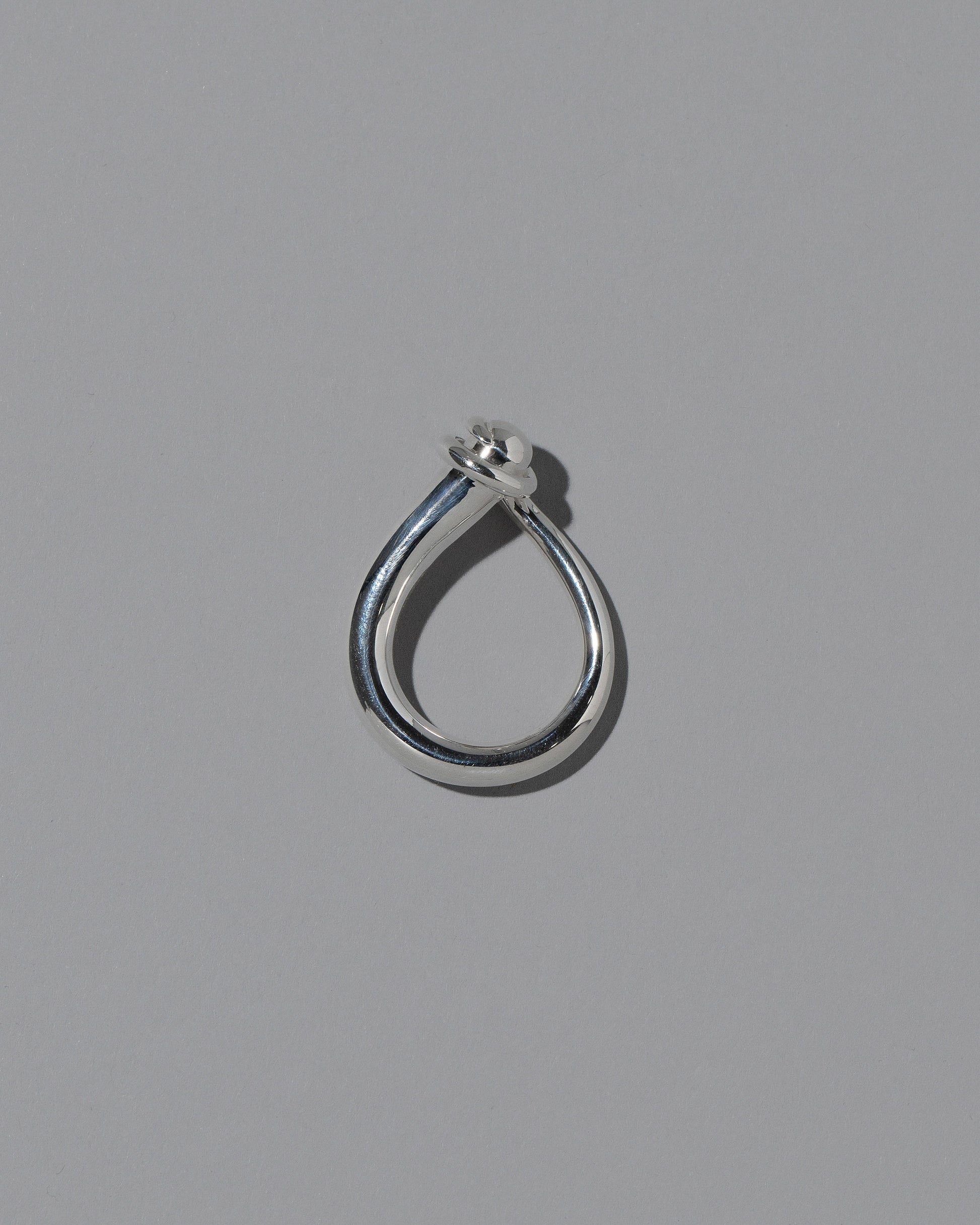 View from the side of the CRZM Sterling Silver Boulder Ring on light color background.