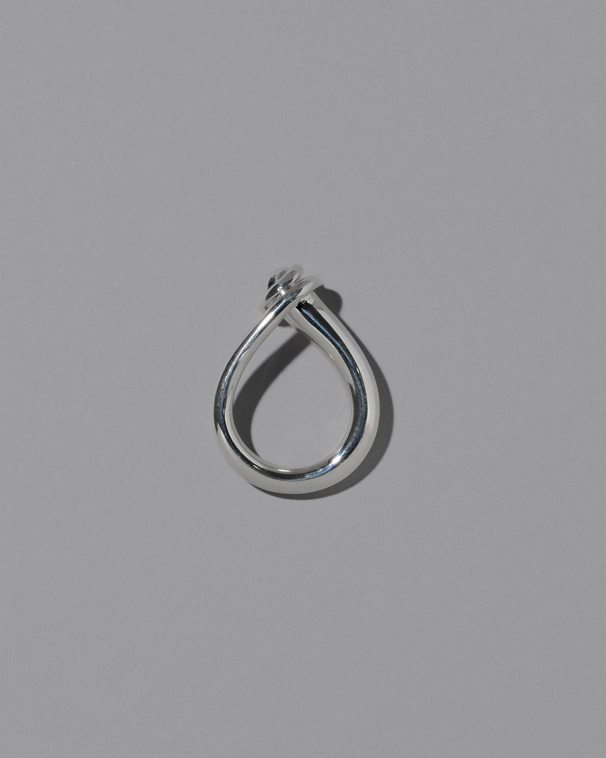 View from the side of the CRZM Sterling Silver Boulder Ring on light color background.