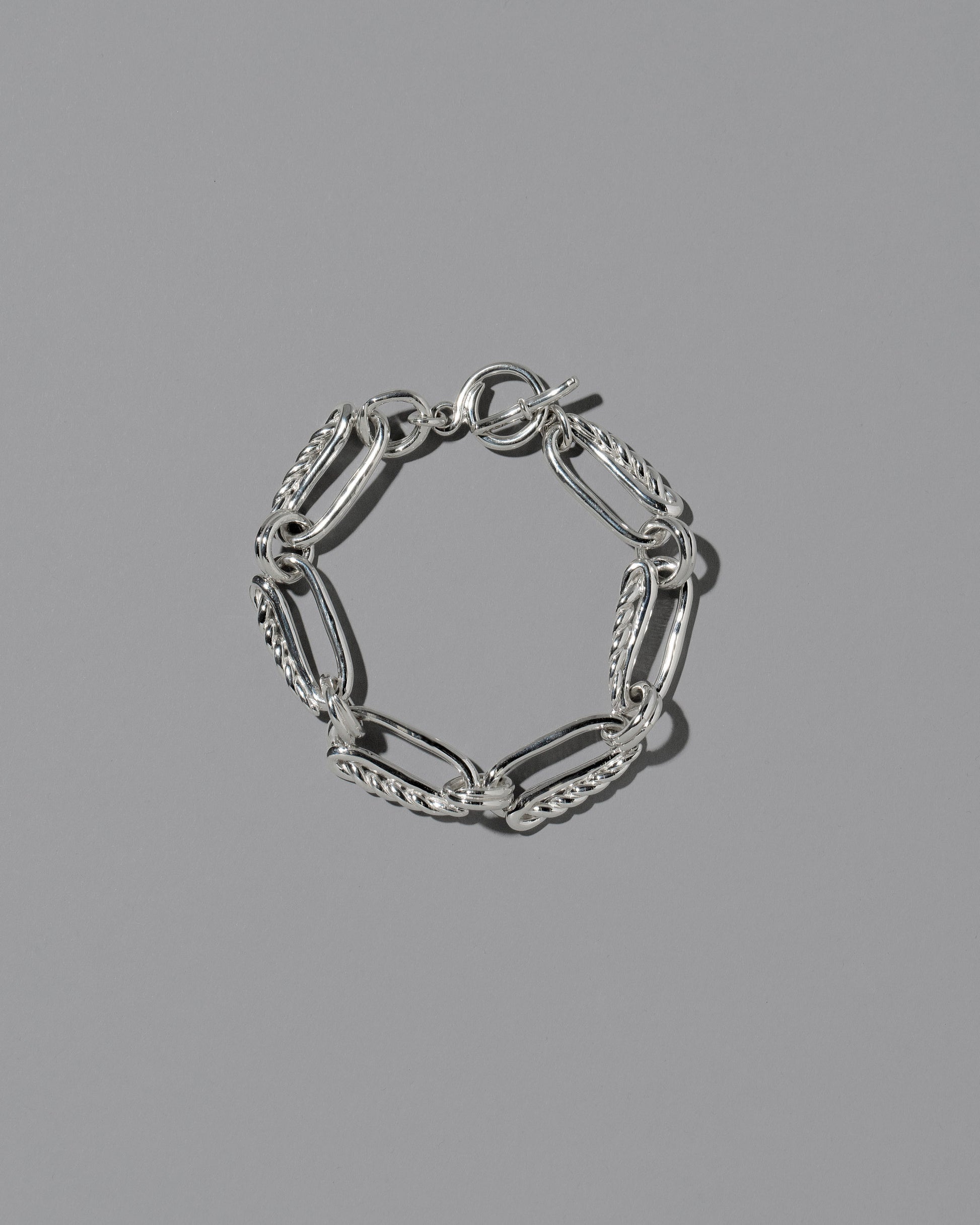 CRZM Sterling Silver Ophiolite Bracelet on light color background.