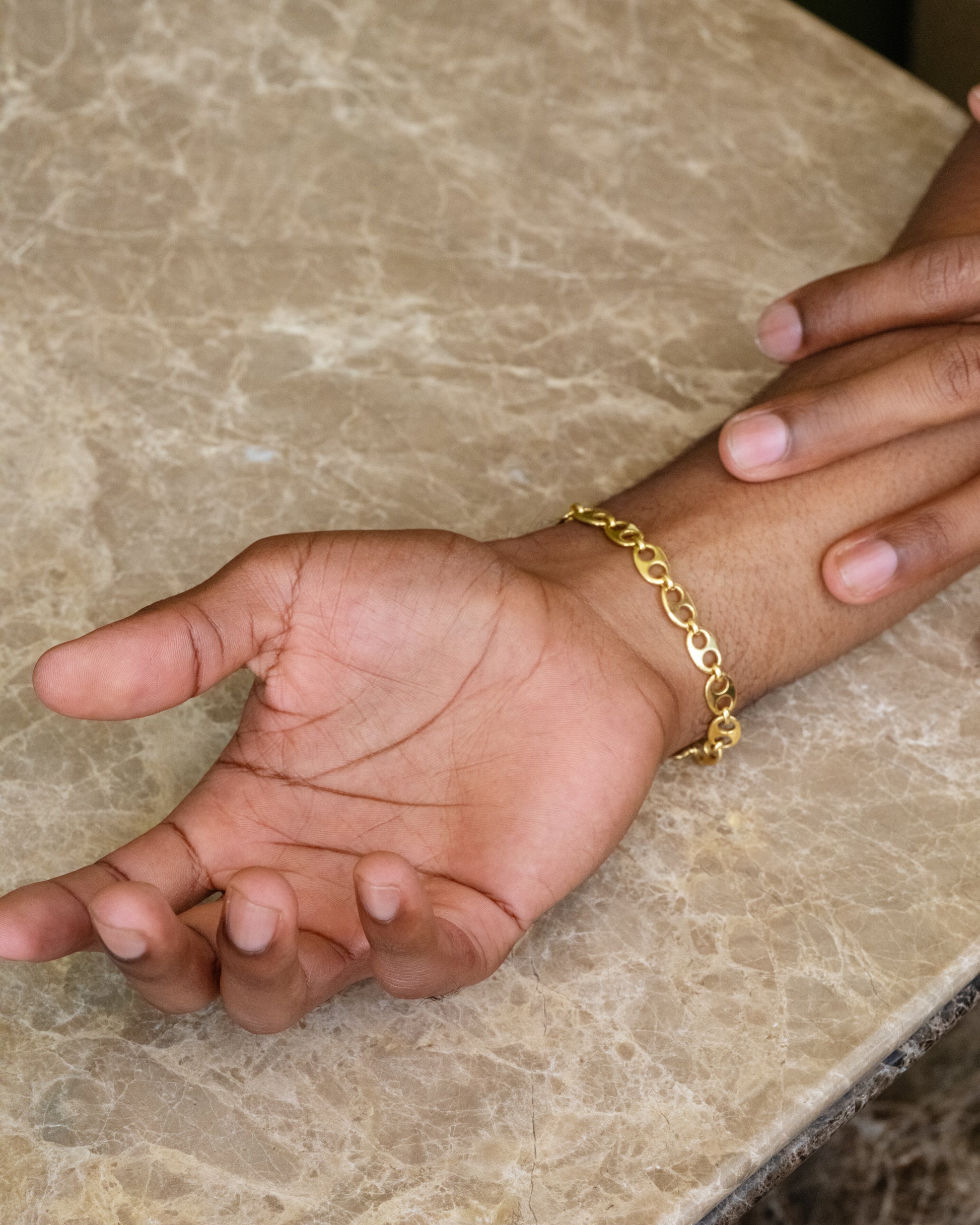 CRZM Gold Solid Gold Yuba Mini Bracelet on male model.