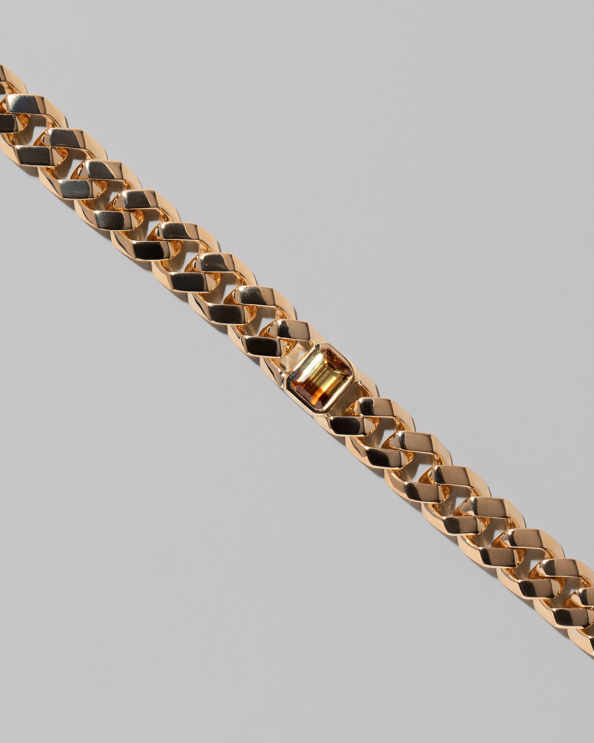 Closeup details of the Identity Chain Bicolor Chrysoberyl Bracelet 001 on light color background.