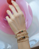 Fluid Bracelet, Link Bracelet, Tenacity Bracelet and Gold Accumulation Bracelet on model.