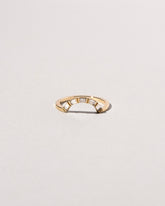 Gold Baguette Curve Band on light color background.