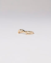 View from the side of the Gold Single Stone Black Diamond Curve Band on light color background.