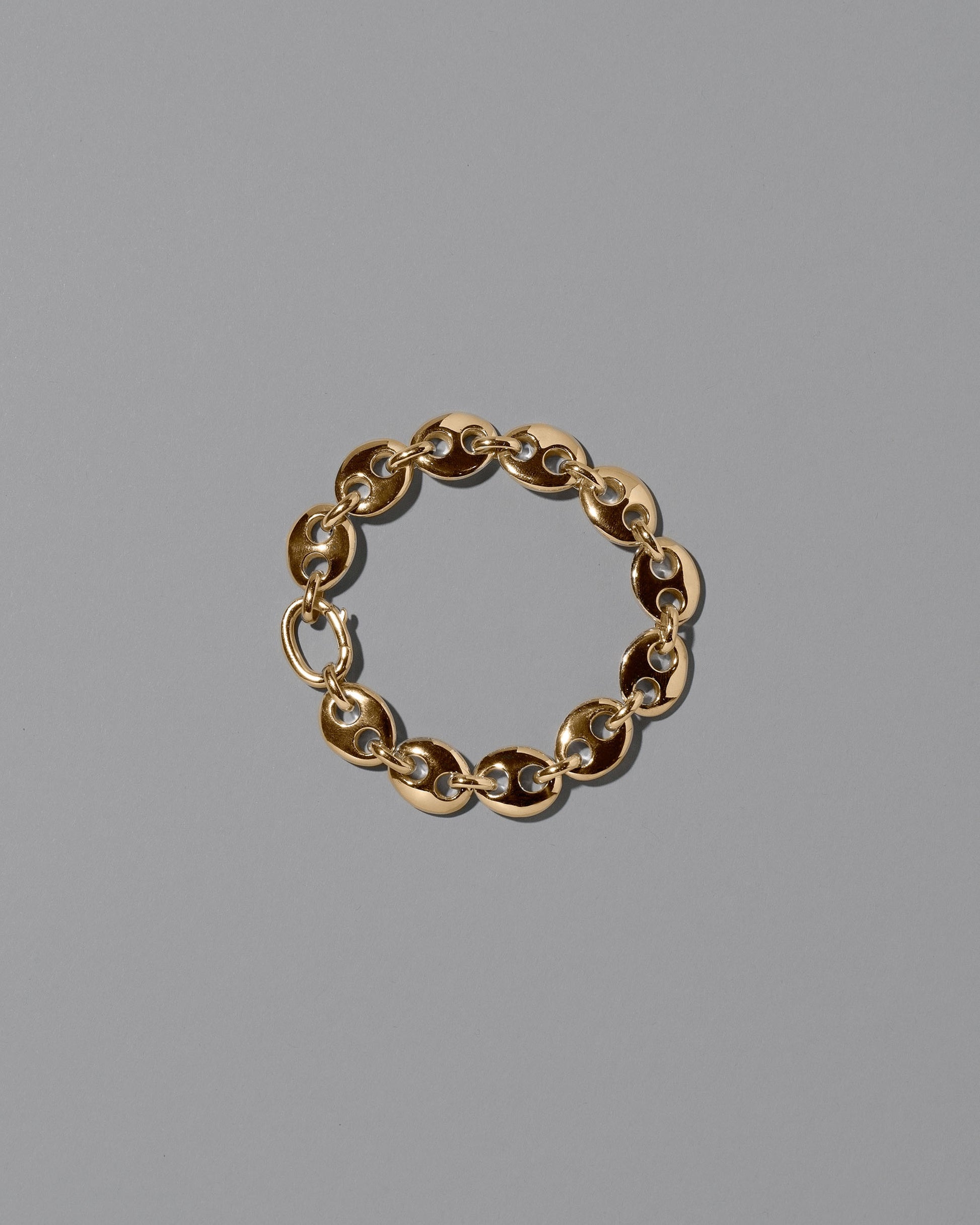 CRZM Gold Medium Bedrock Bracelet on light color background.