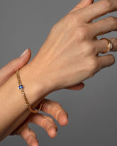 Gold Blue Sapphire Fold Bracelet on model.