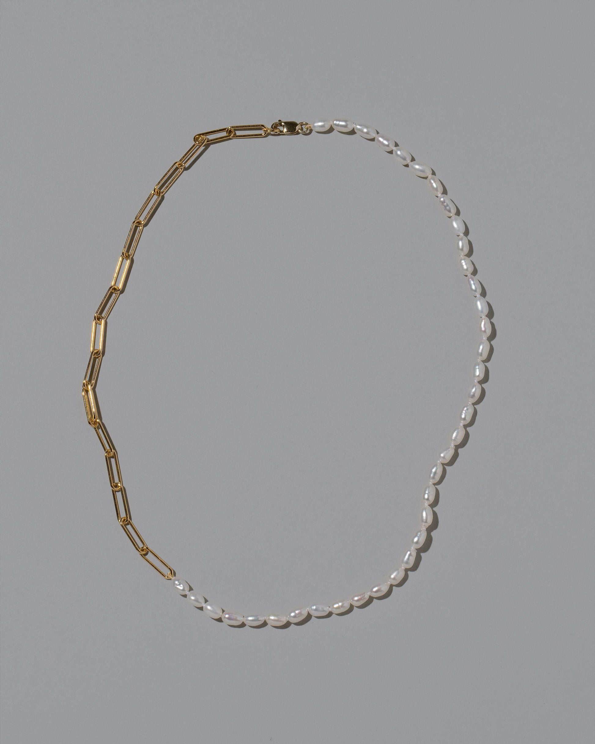 Rice Pearl Long Oval Necklace on light color background.