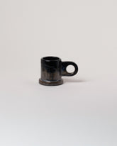 Echo Park Pottery by Peter Shire Black Double Dip Espresso Mug on light color background.