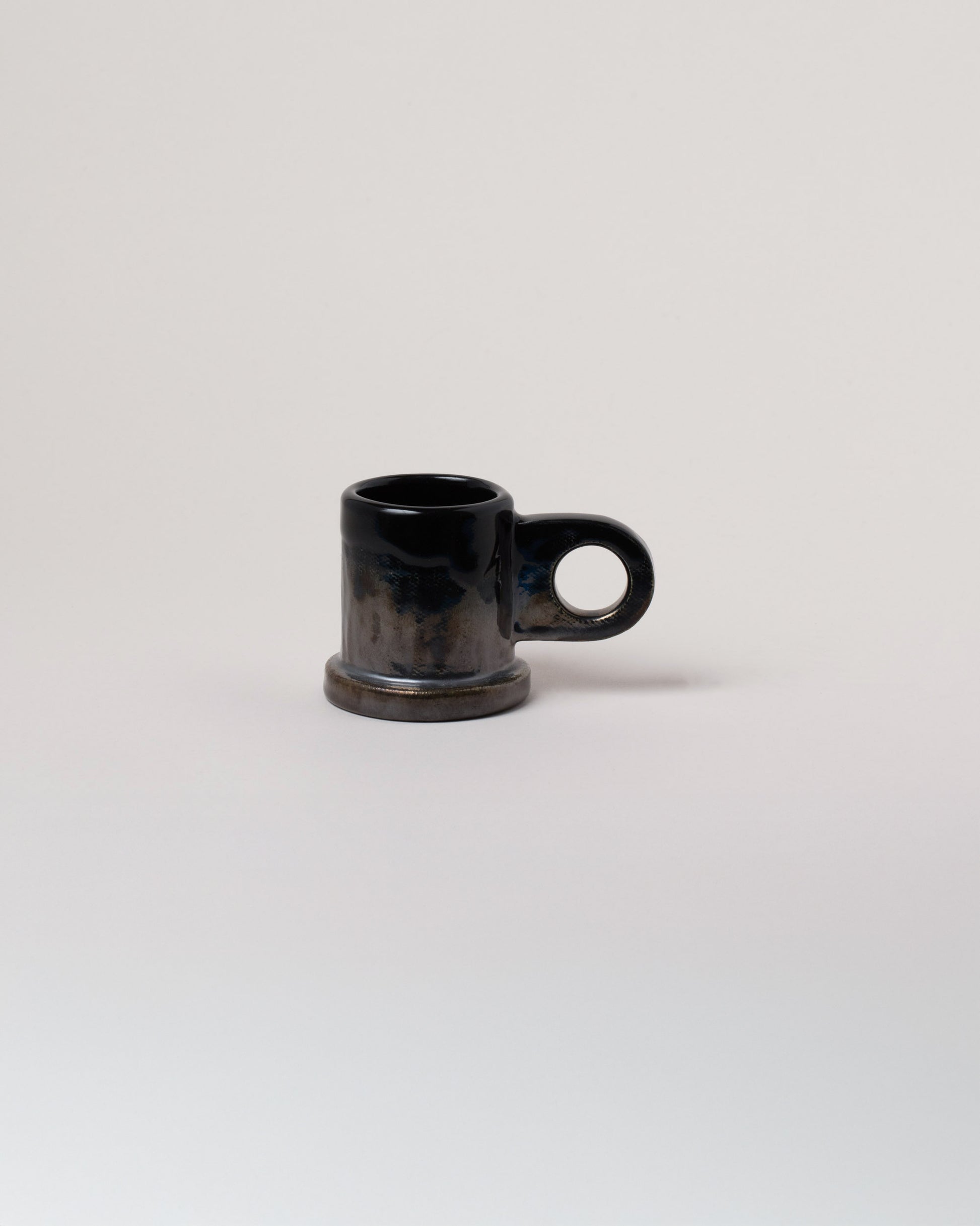 Echo Park Pottery by Peter Shire Black Double Dip Espresso Mug on light color background.