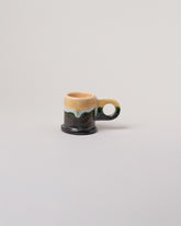 Echo Park Pottery by Peter Shire Pink, Yellow & Gunmetal Double Dip Espresso Mug on light color background.