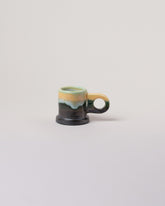 Echo Park Pottery by Peter Shire Blue, Yellow & Gunmetal Double Dip Espresso Mug on light color background.