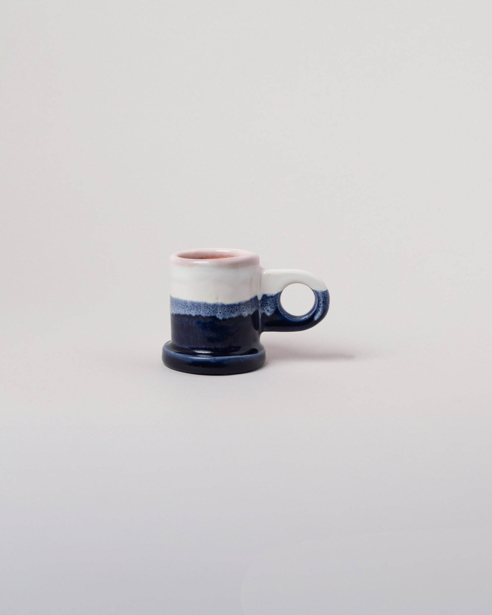 Echo Park Pottery by Peter Shire White & Navy Double Dip Espresso Mug on light color background.