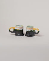 Echo Park Pottery by Peter Shire Yellow & Gunmetal Double Dip Espresso Mug Set on light color background.