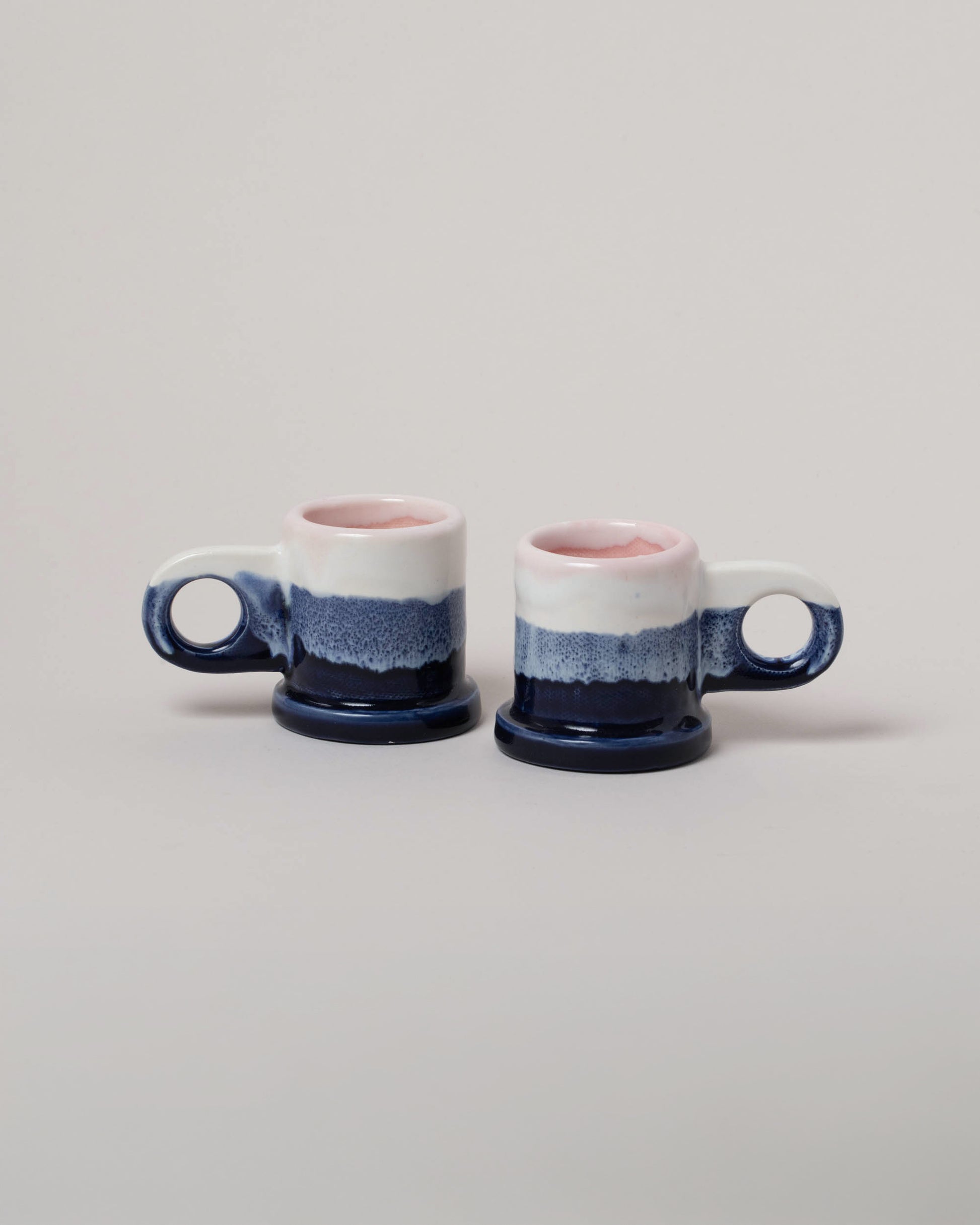 Echo Park Pottery by Peter Shire White & Navy Double Dip Espresso Mug Set on light color background.