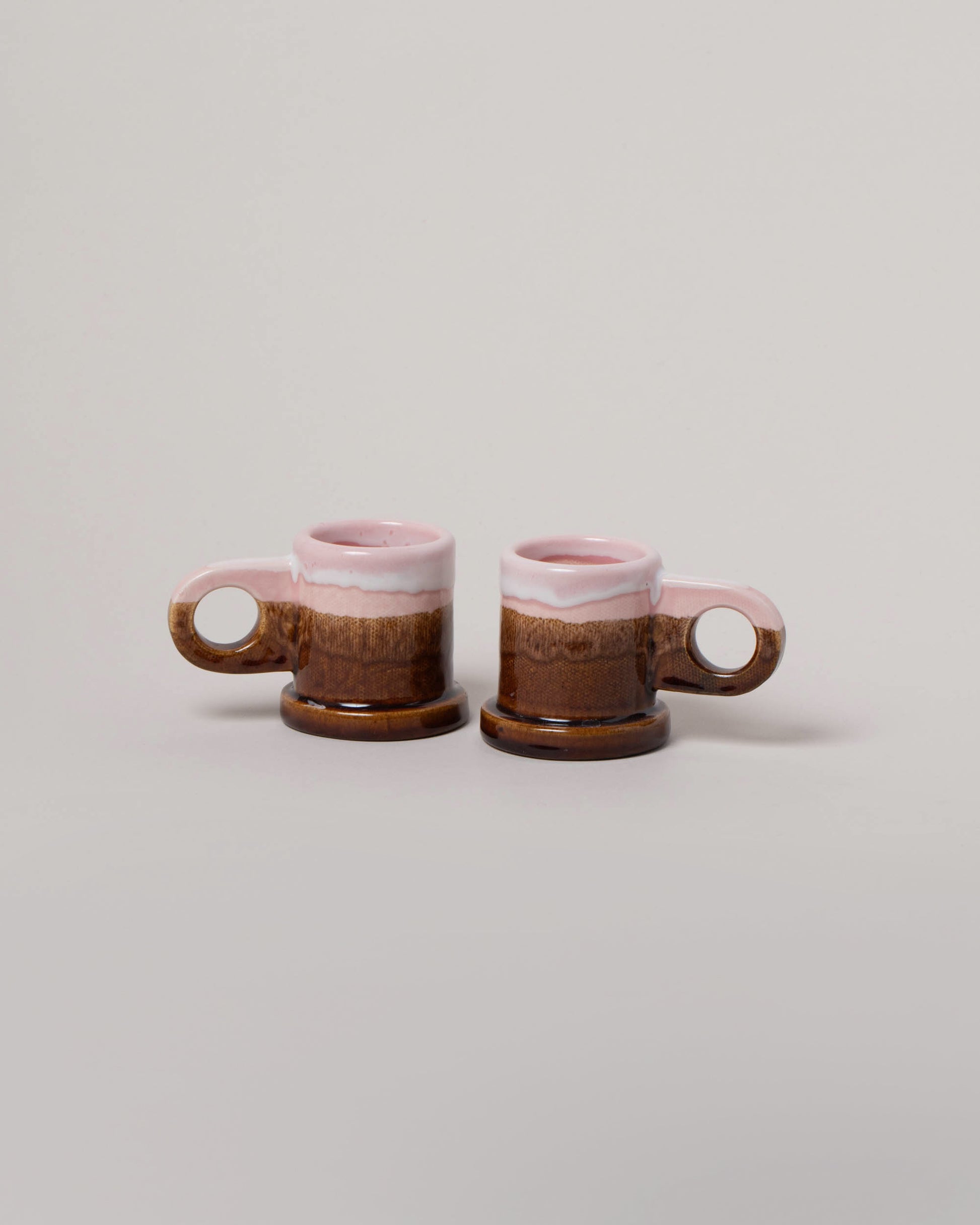 Echo Park Pottery by Peter Shire Pink & Brown Double Dip Espresso Mug Set on light color background.