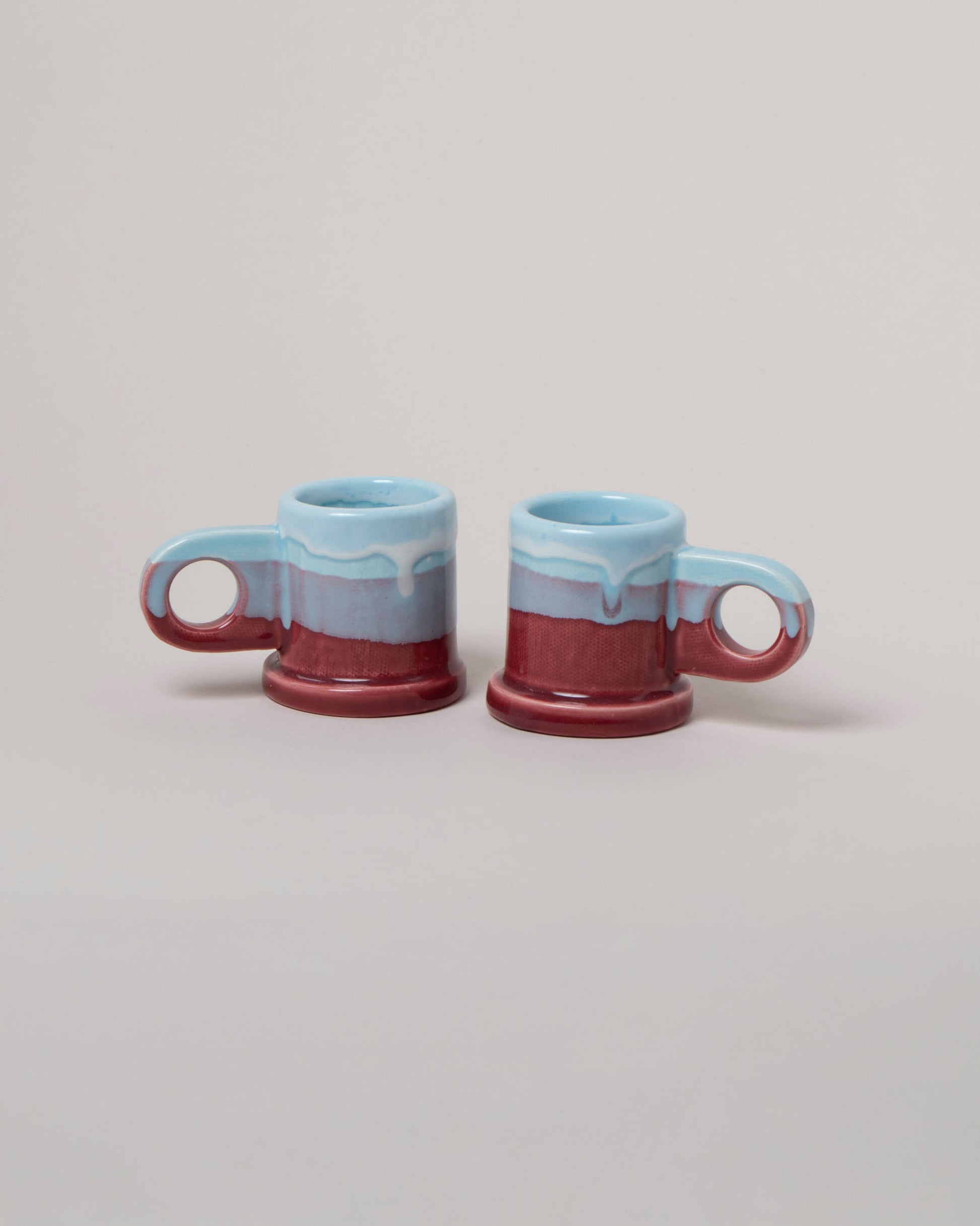 Echo Park Pottery by Peter Shire Baby Blue & Ruby Double Dip Espresso Mug Set on light color background.