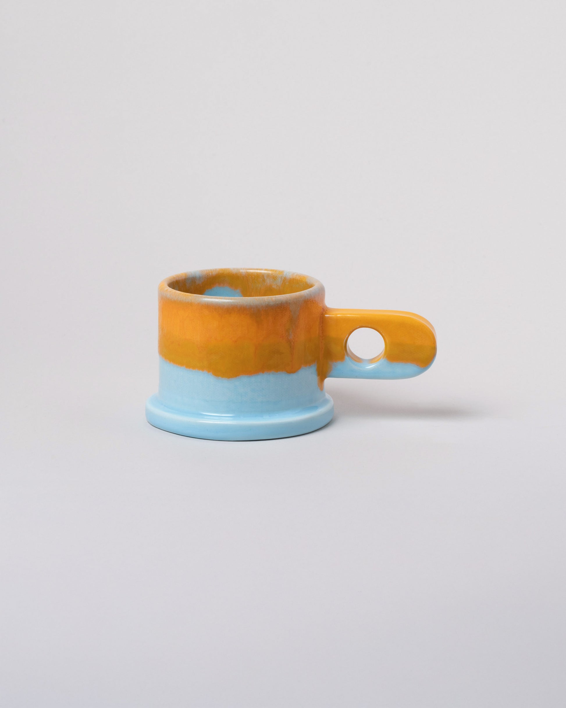 Echo Park Pottery by Peter Shire Orange & Blue Double Dip Mug on light color background.