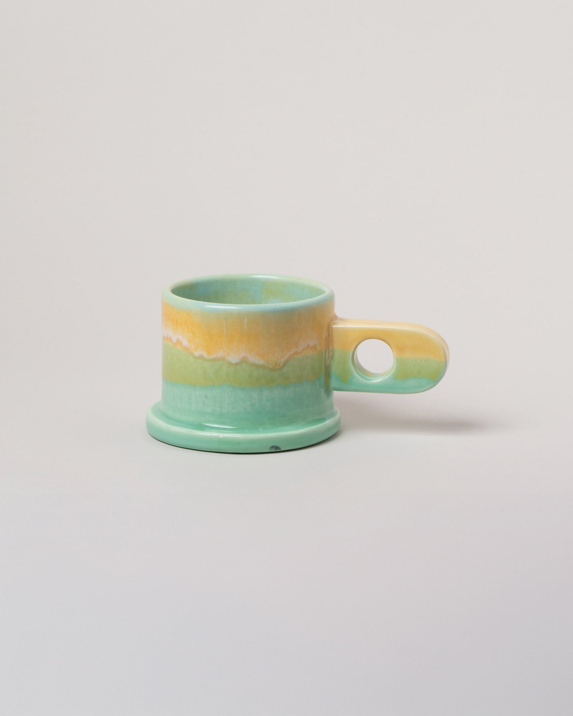 Echo Park Pottery by Peter Shire Butter & Seafoam Double Dip Mug on light color background.