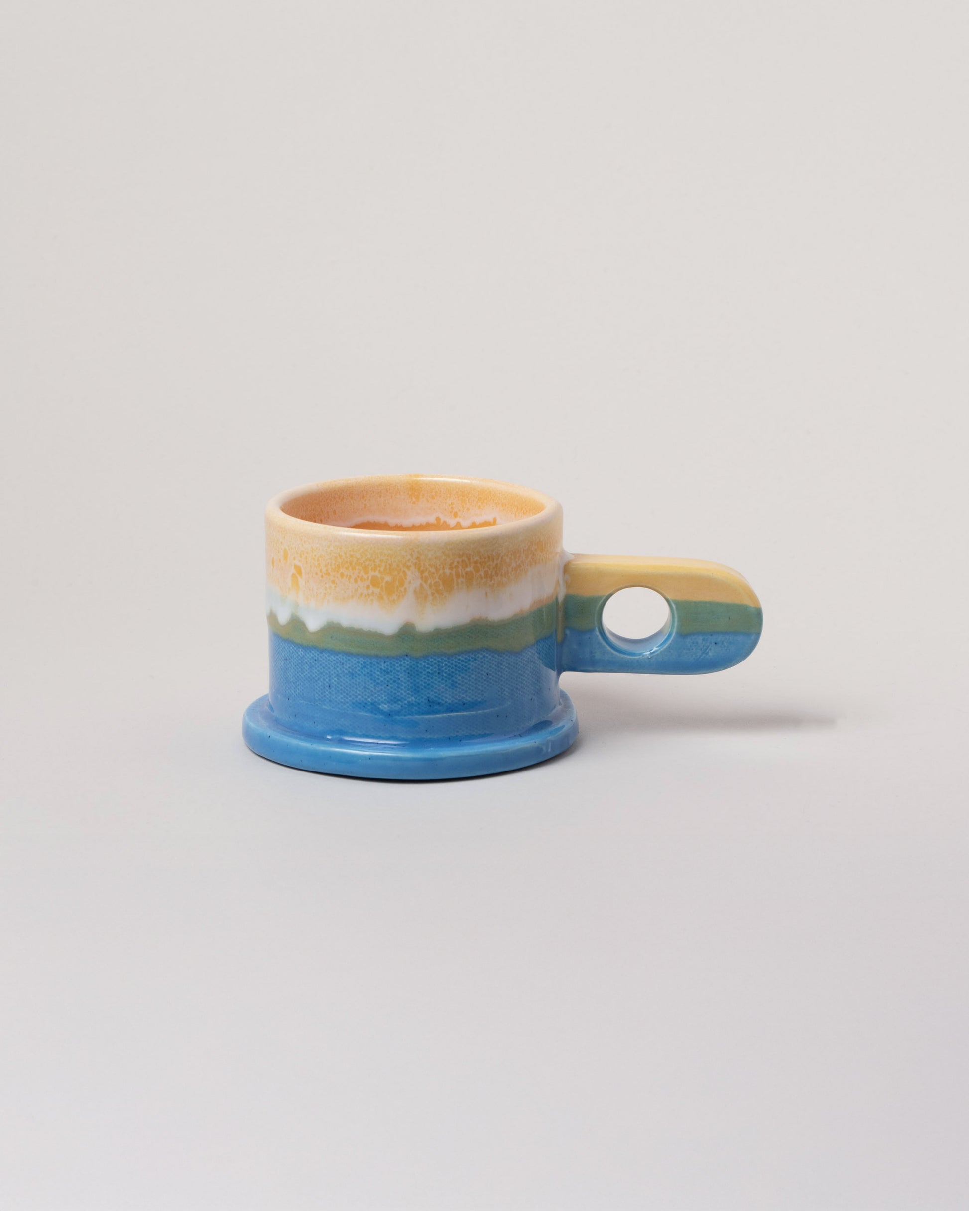 Echo Park Pottery by Peter Shire Yellow & Blue Double Dip Mug on light color background.