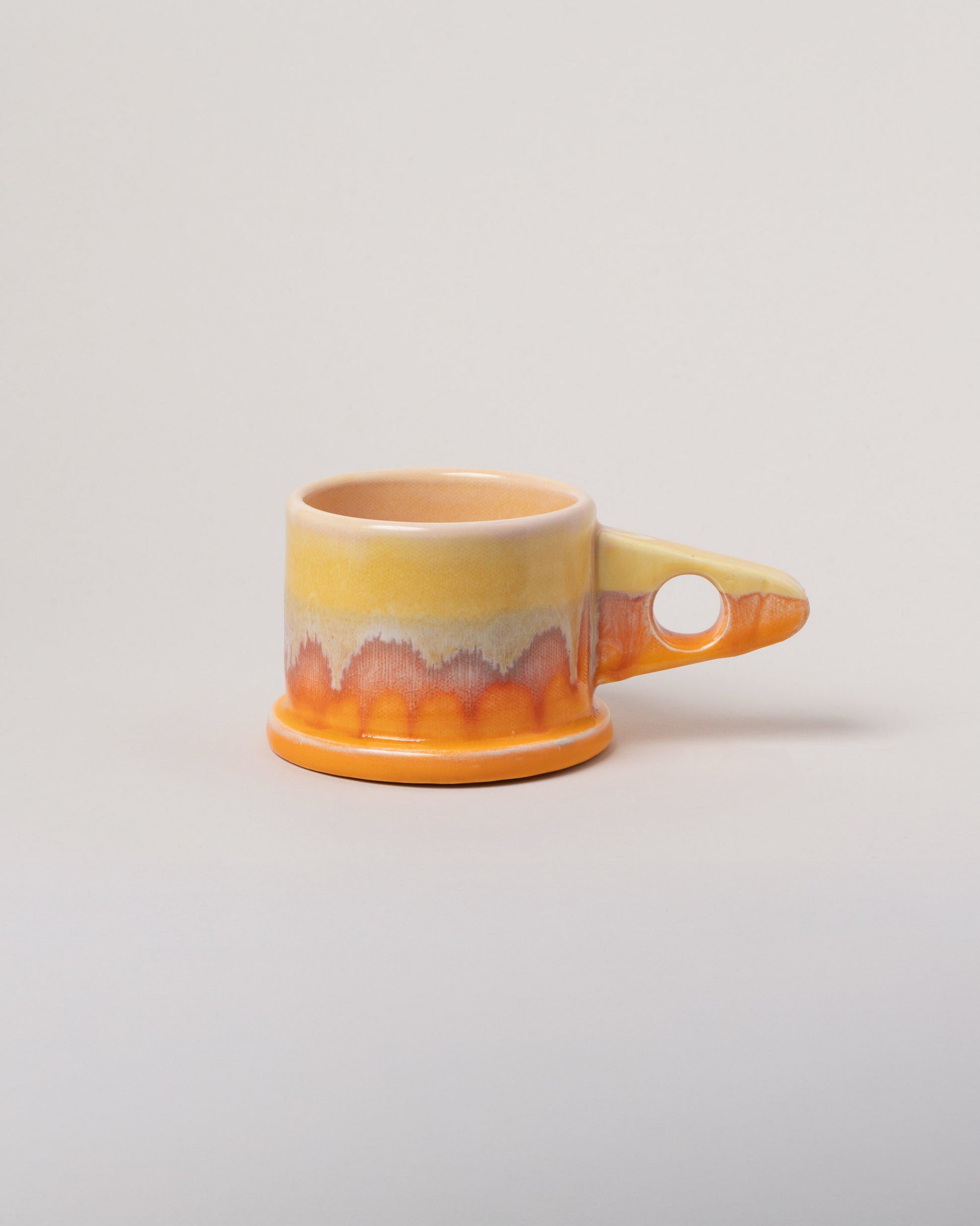 Echo Park Pottery by Peter Shire Yellow & Orange Double Dip Mug on light color background.