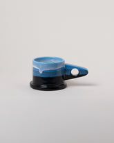 Echo Park Pottery by Peter Shire Blue & Black Double Dip Mug on light color background.