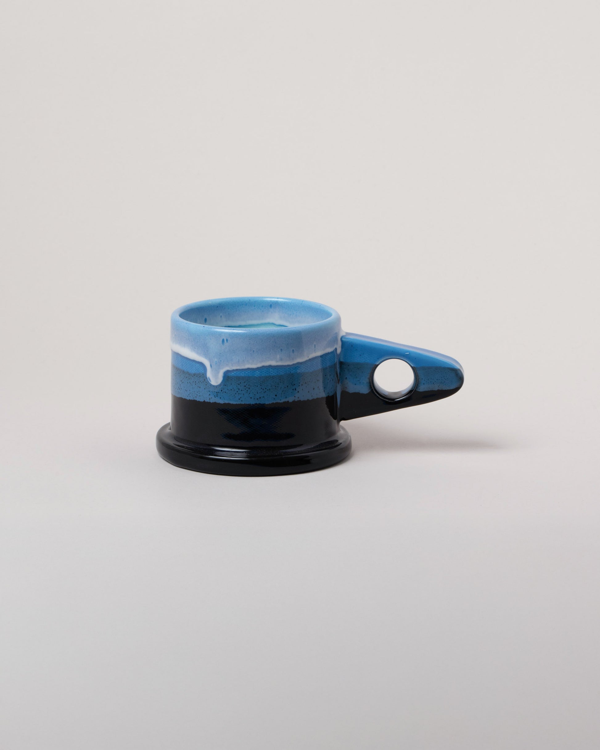 Echo Park Pottery by Peter Shire Blue & Black Double Dip Mug on light color background.