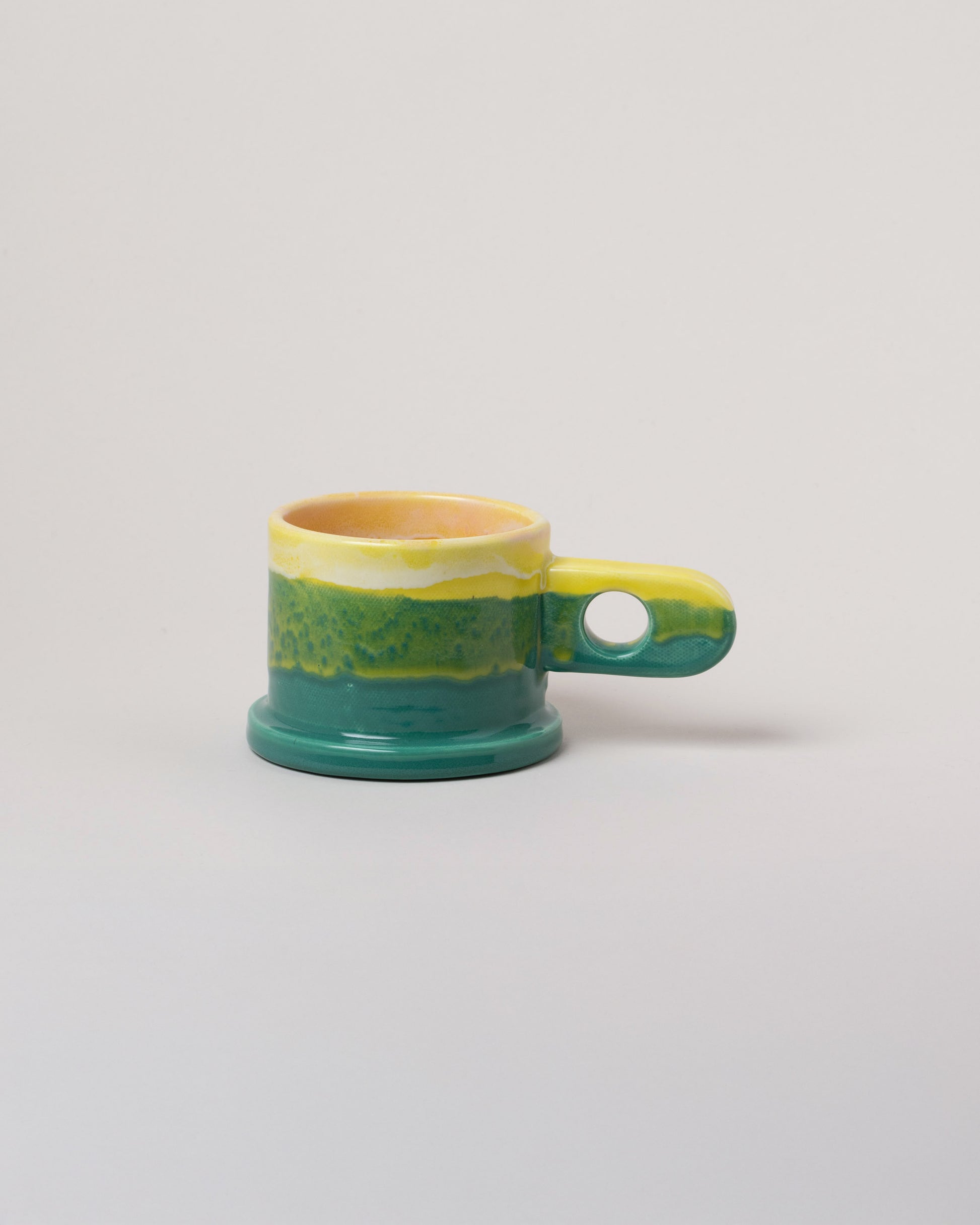 Echo Park Pottery by Peter Shire Yellow & Green Double Dip Mug on light color background.