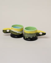 Echo Park Pottery by Peter Shire Lime & Gunmetal Double Dip Mug Set on light color background.