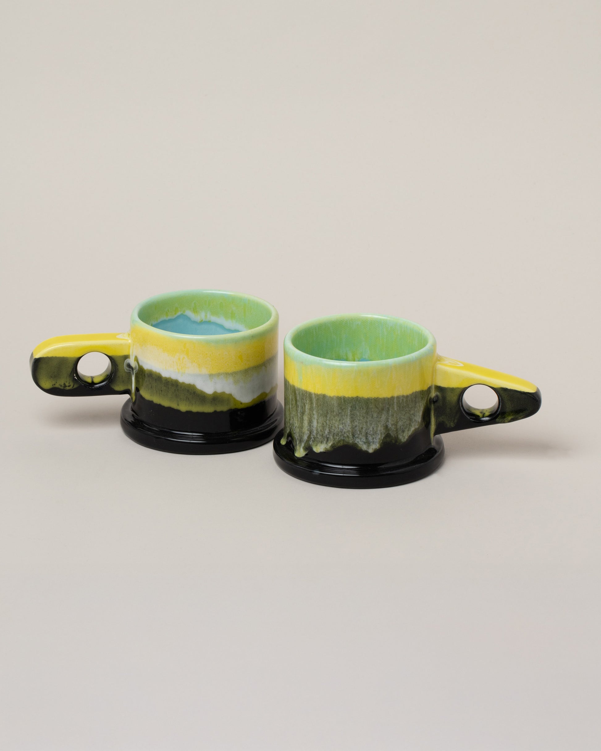 Echo Park Pottery by Peter Shire Lime & Gunmetal Double Dip Mug Set on light color background.