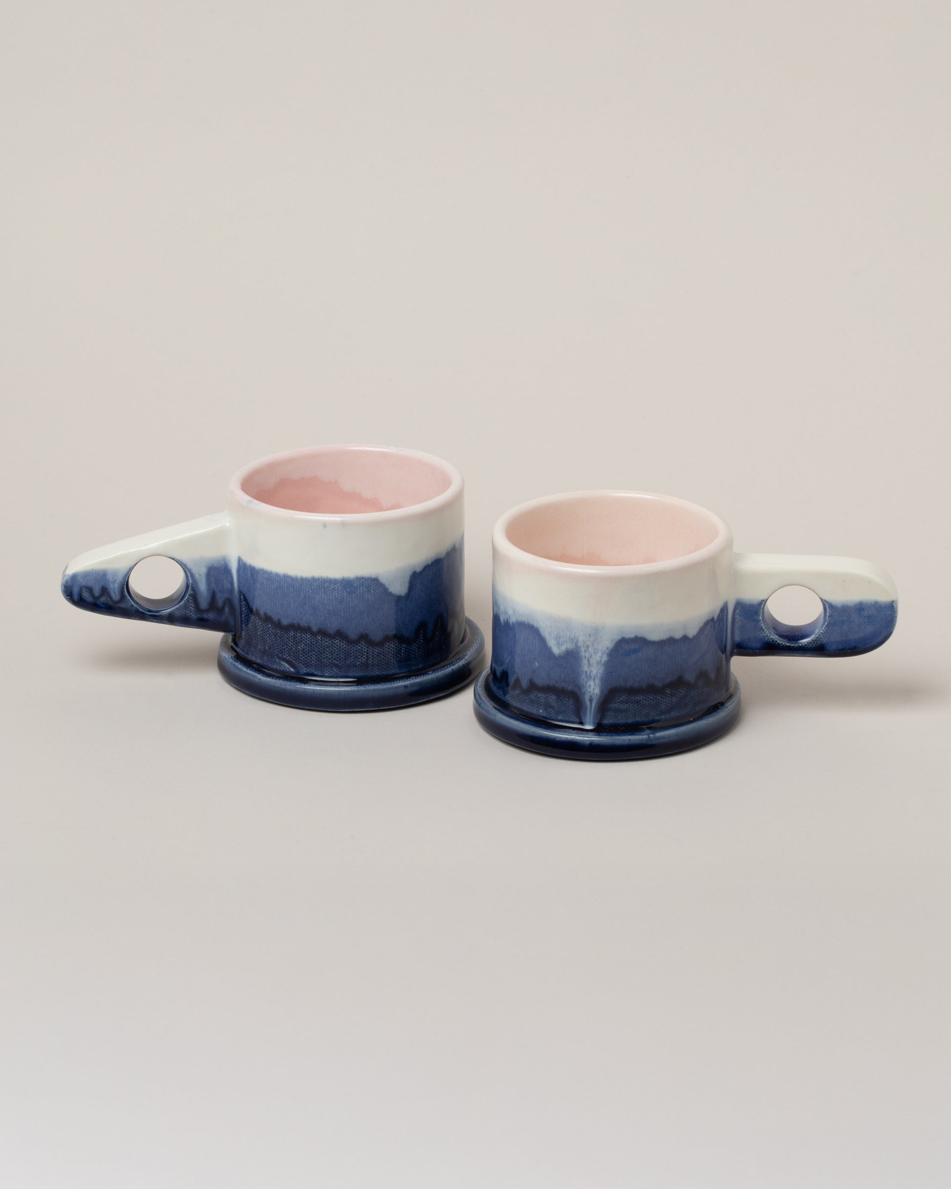 Echo Park Pottery by Peter Shire White & Navy Double Dip Mug Set on light color background.