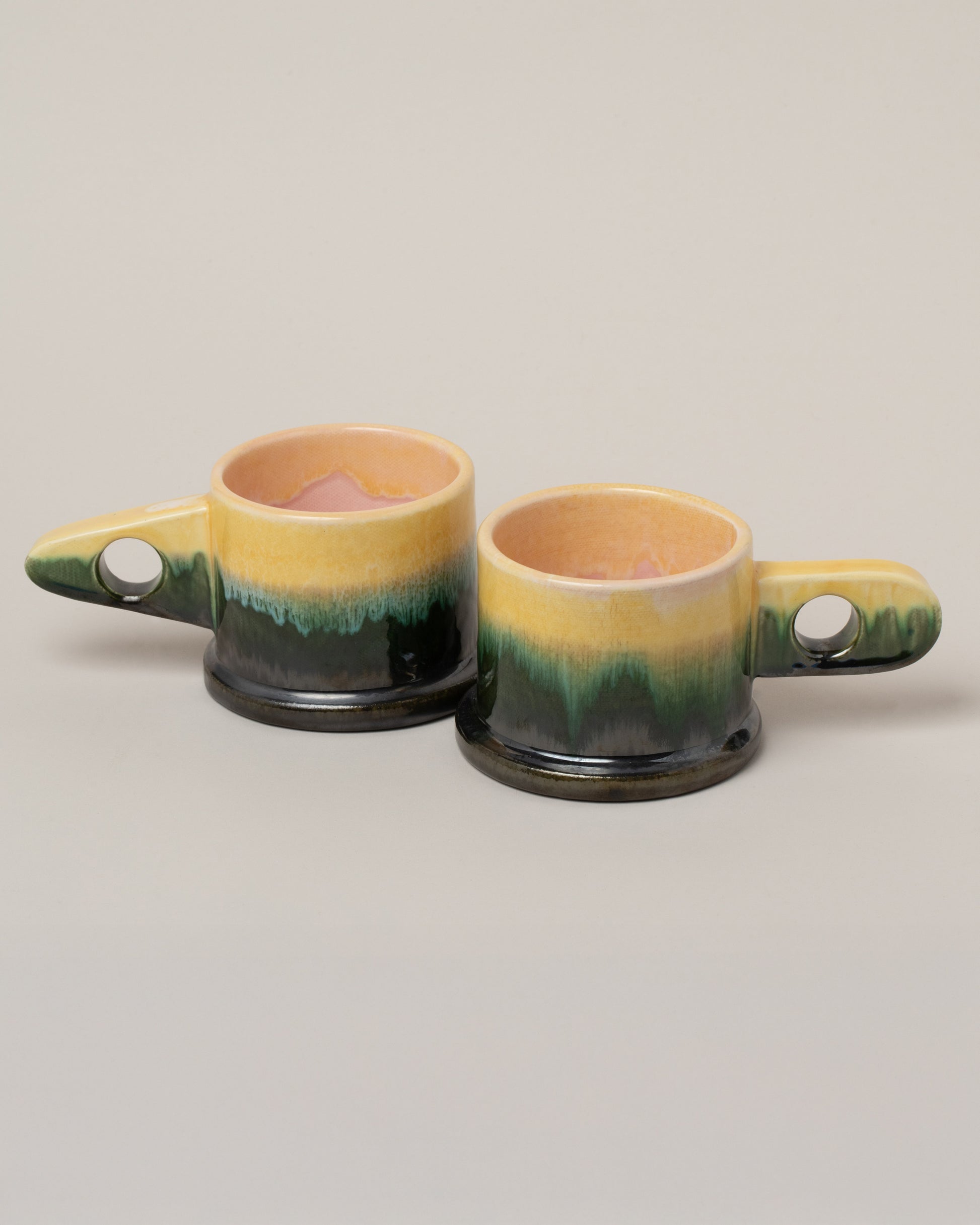 Echo Park Pottery by Peter Shire Yellow & Gunmetal Double Dip Espresso Mug Set on light color background.