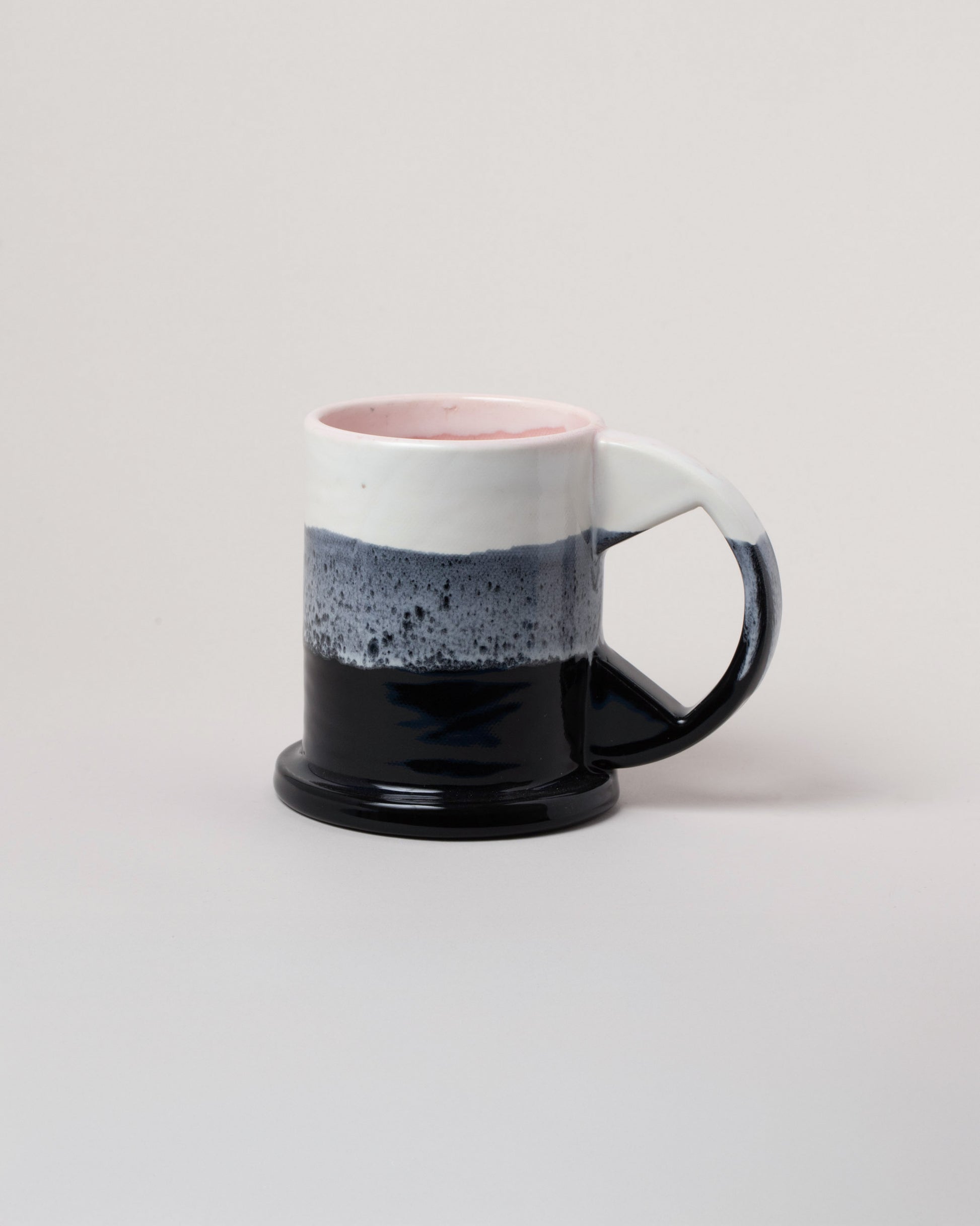 Echo Park Pottery by Peter Shire White, Gray and Black Large Double Dip Mug on light color background.
