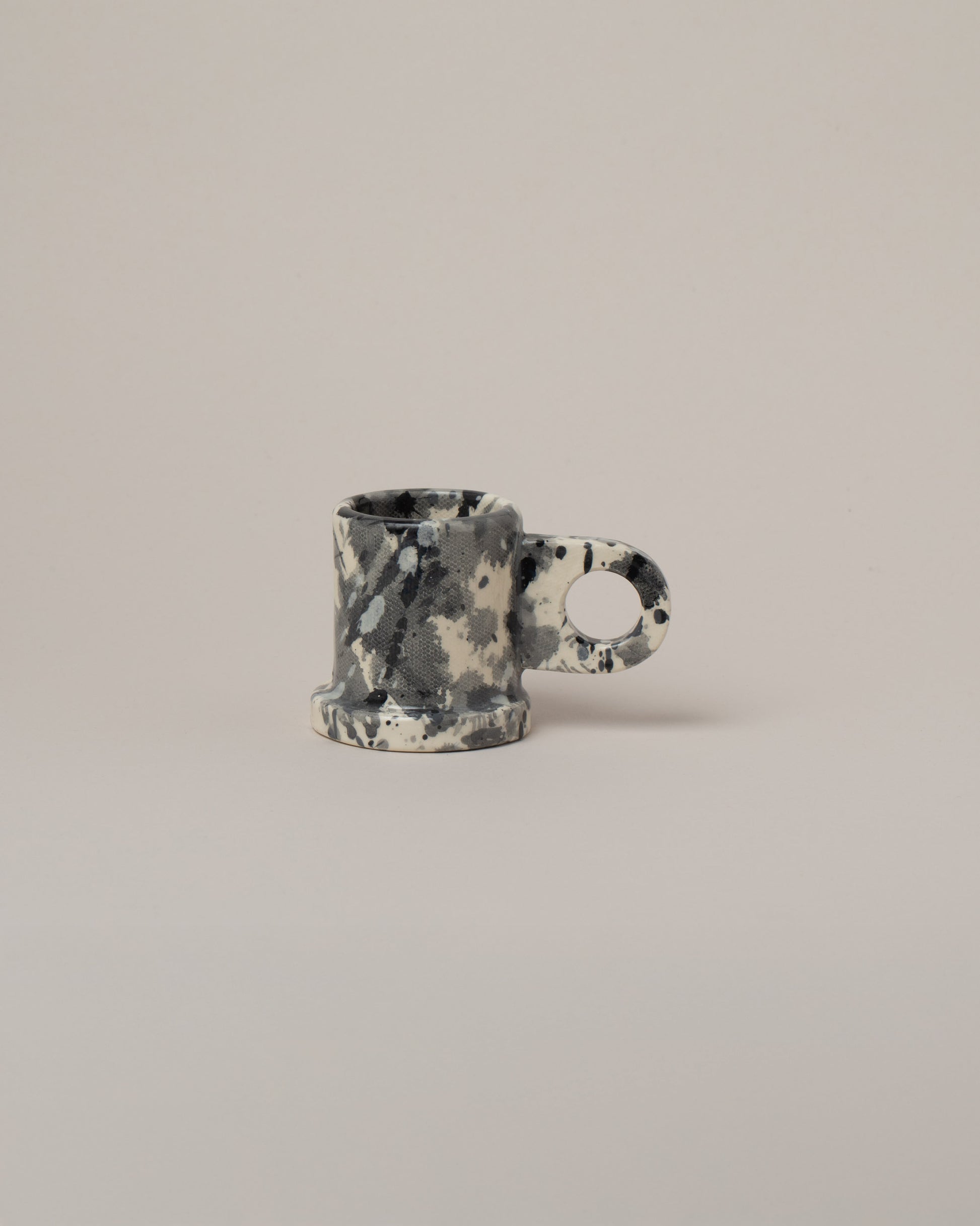 Echo Park Pottery by Peter Shire Black Splatter Espresso Mug on light color background.