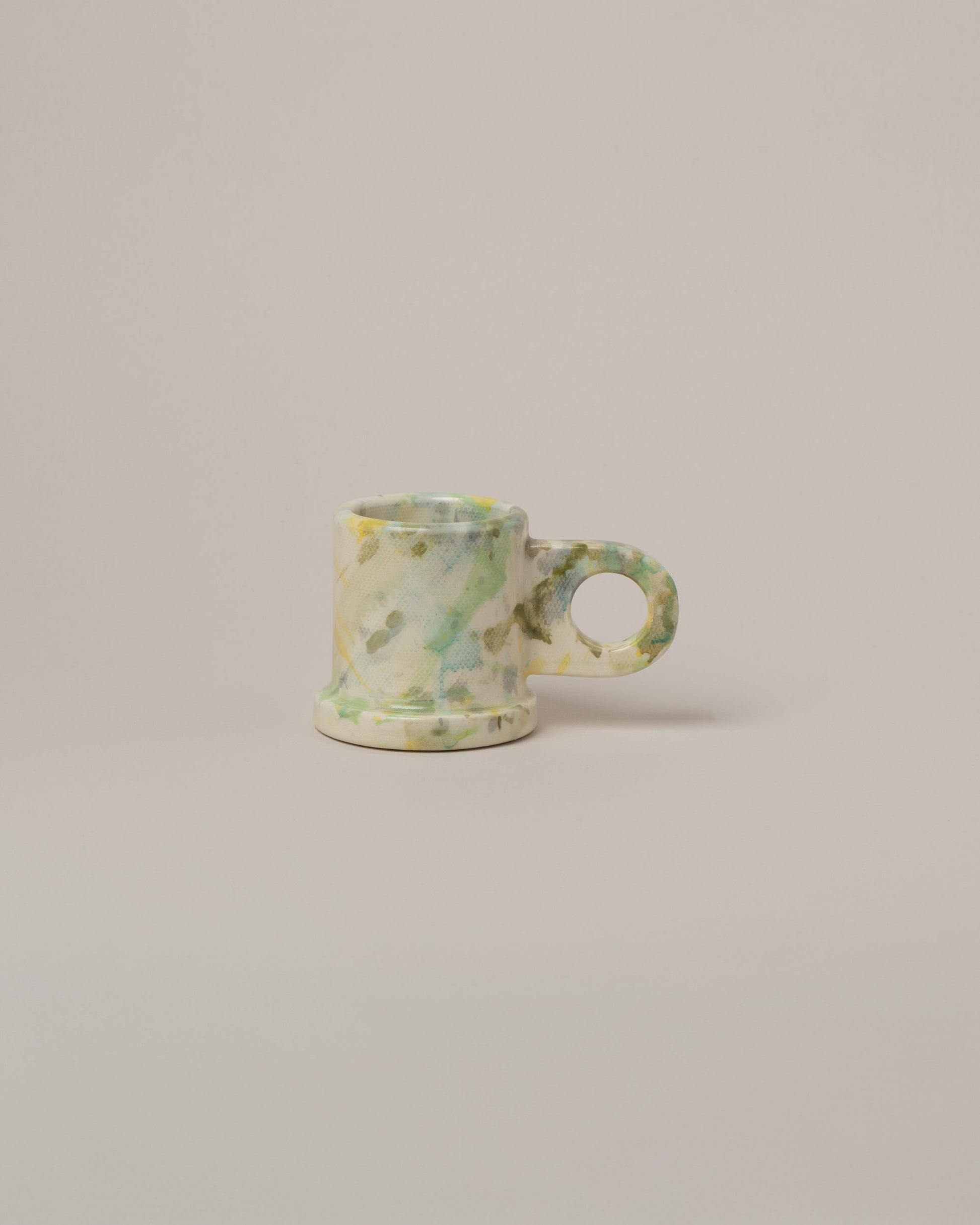 Echo Park Pottery by Peter Shire Lime Splatter Espresso Mug on light color background.