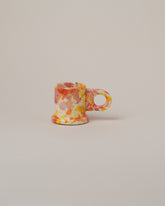 Echo Park Pottery by Peter Shire Orange & Pink Splatter Espresso Mug on light color background.