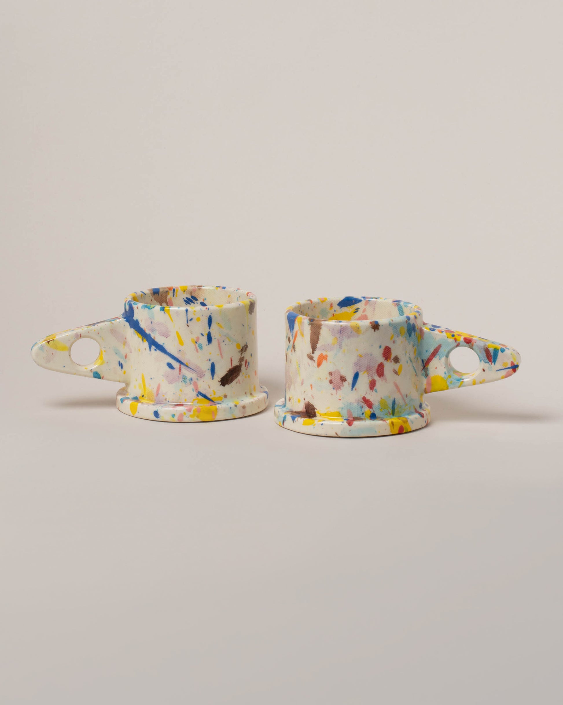 Echo Park Pottery by Peter Shire Blue & Yellow Splatter Mug Set on light color background.
