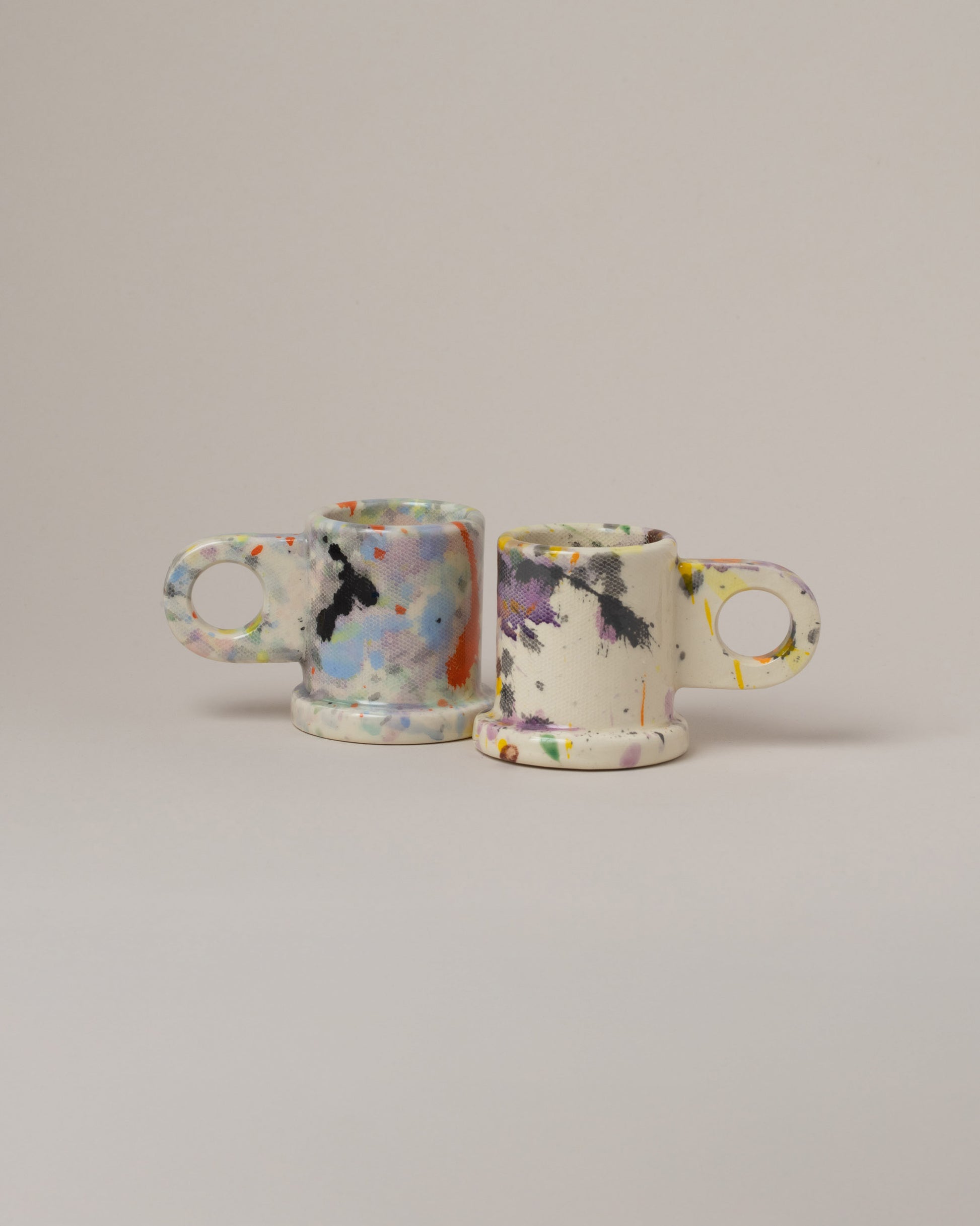 Echo Park Pottery by Peter Shire Purple & Yellow Splatter Espresso Mug Set on light color background.