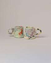 Echo Park Pottery by Peter Shire Yellow & Purple Splatter Espresso Mug Set on light color background.