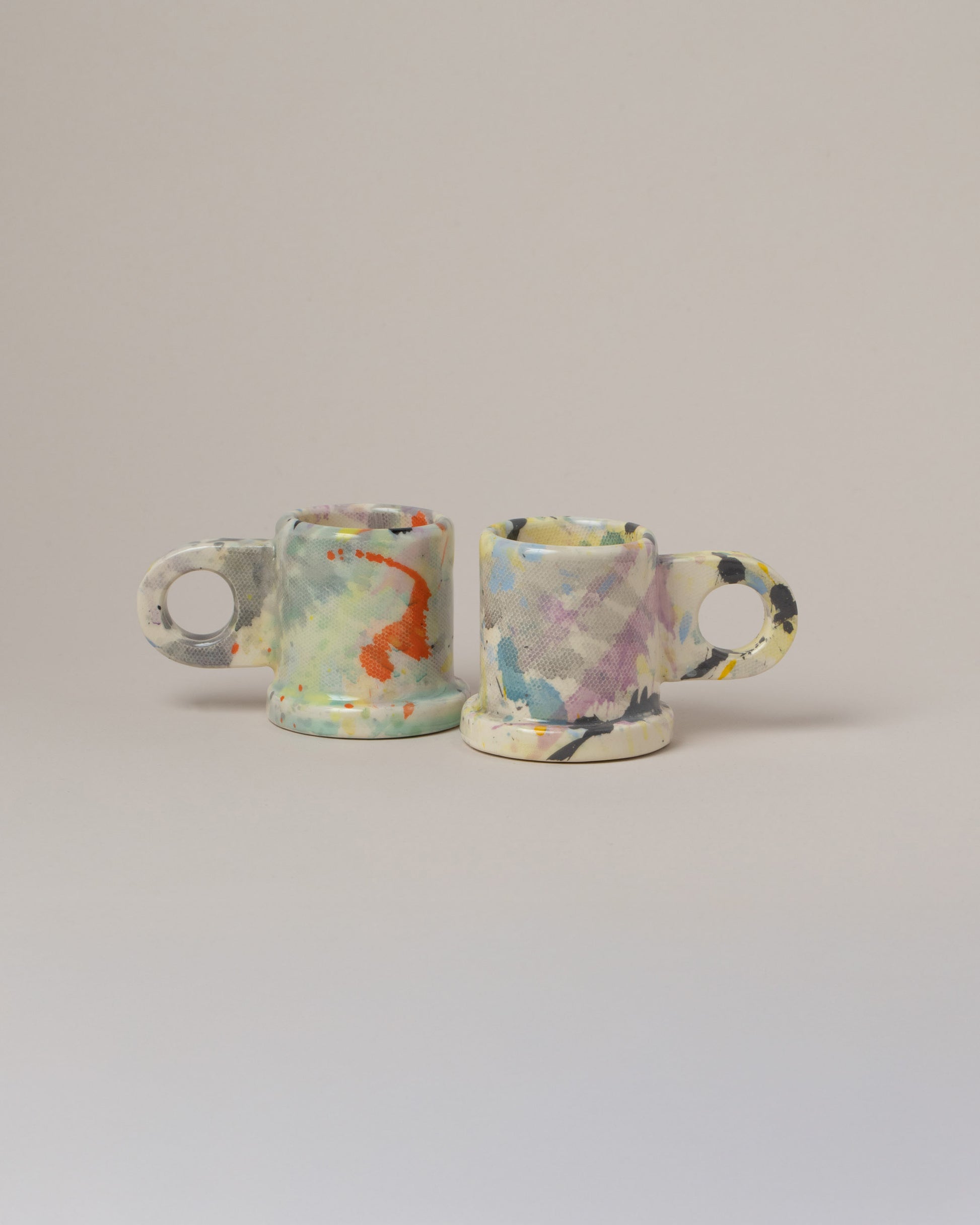 Echo Park Pottery by Peter Shire Yellow & Purple Splatter Espresso Mug Set on light color background.
