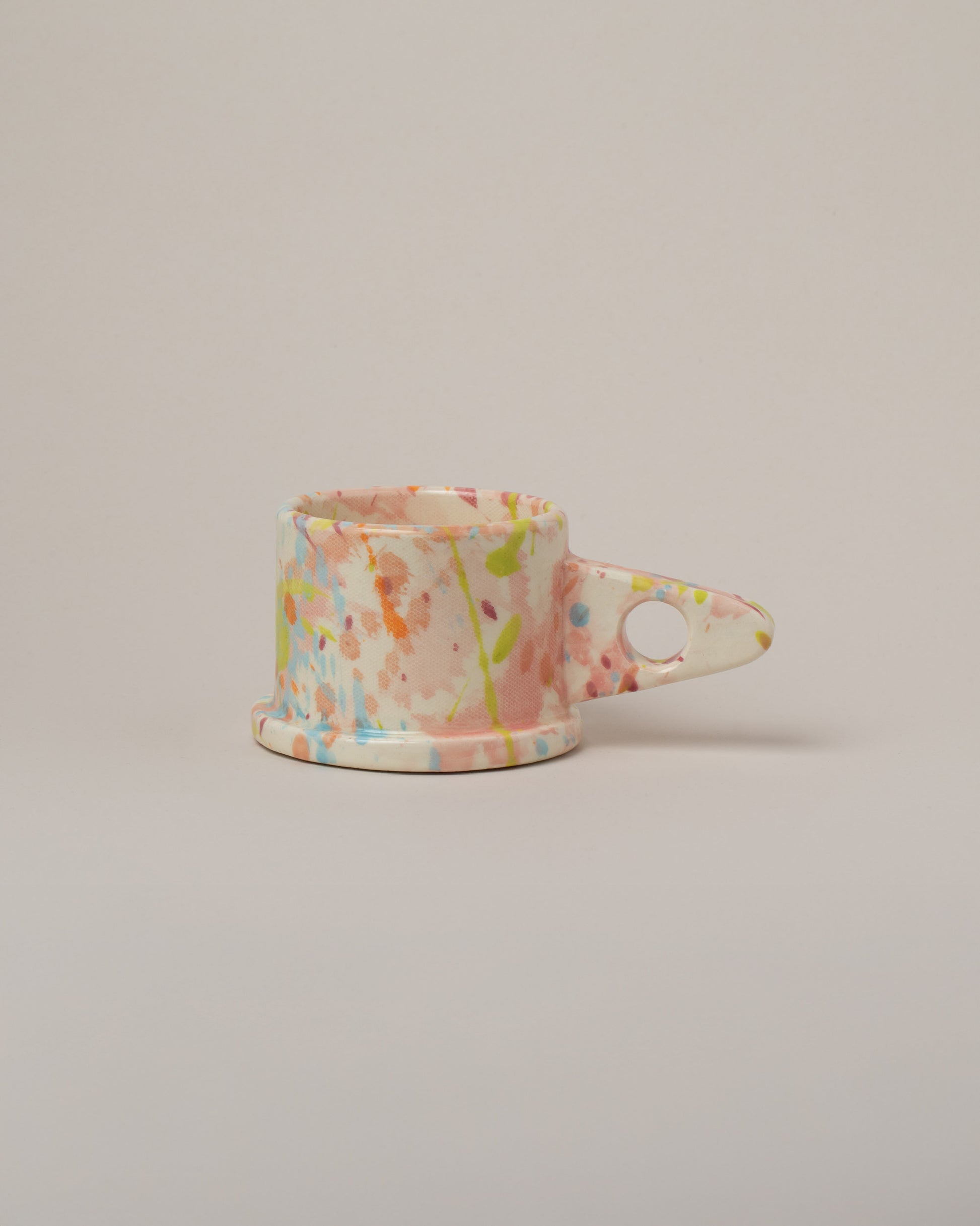 Echo Park Pottery by Peter Shire Pink & Sky Blue Splatter Mug on light color background.